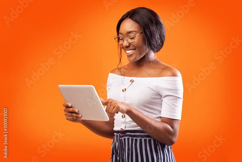 Happy African American Woman Using Digital Tablet Standing, Studio Shot