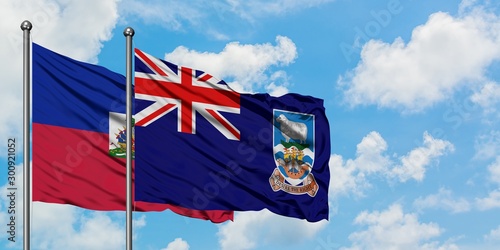 Obraz na płótnie Haiti and Falkland Islands flag waving in the wind against white cloudy blue sky together