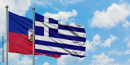 Fotografie Haiti and Greece flag waving in the wind against white cloudy blue sky together