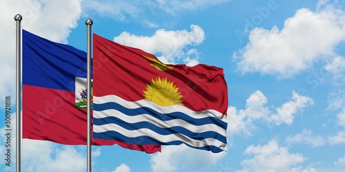 Fotografie Haiti and Kiribati flag waving in the wind against white cloudy blue sky together