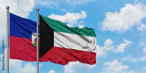 Φωτογραφία Haiti and Kuwait flag waving in the wind against white cloudy blue sky together
