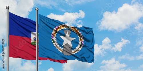 Fotografie Haiti and Northern Mariana Islands flag waving in the wind against white cloudy blue sky together