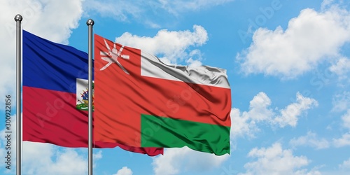 Εκτύπωση καμβά Haiti and Oman flag waving in the wind against white cloudy blue sky together