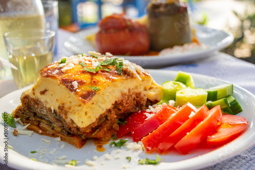 Greek traditional moussaka on a white plate served in taverna, Greece