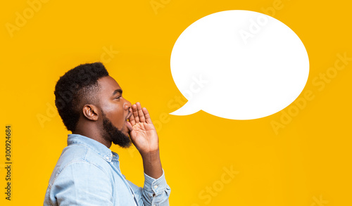 African american man making announcement at white blank speech bubble
