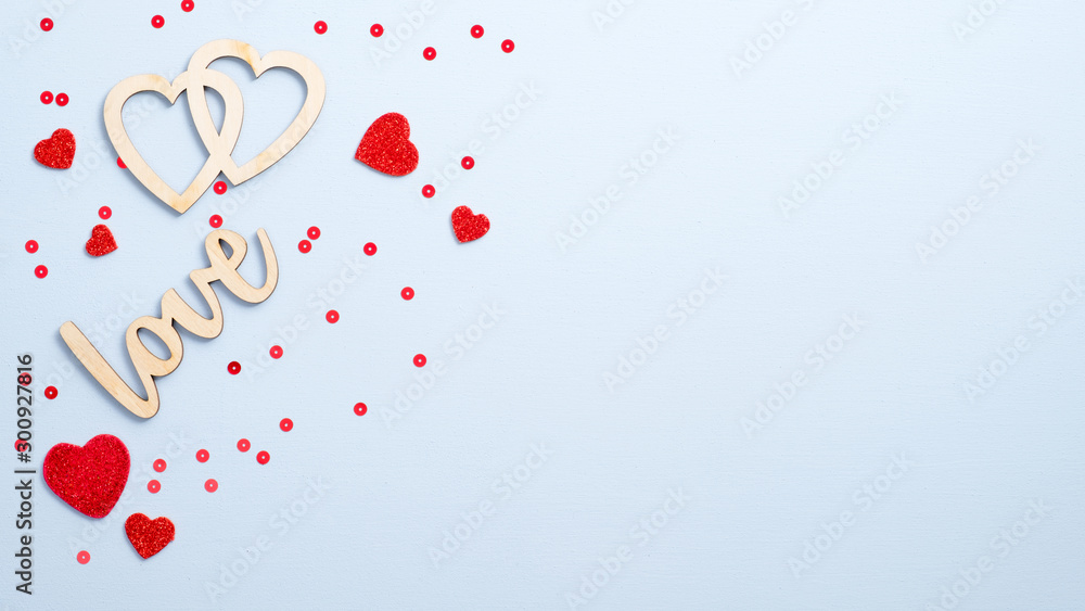 Valentine's Day concept. Flat lay wooden sign "Love" and hearts on blue background with red decor. Top view symbols of love for Happy Women's, Mother's, Valentine's Day, birthday greeting card design - obrazy, fototapety, plakaty 
