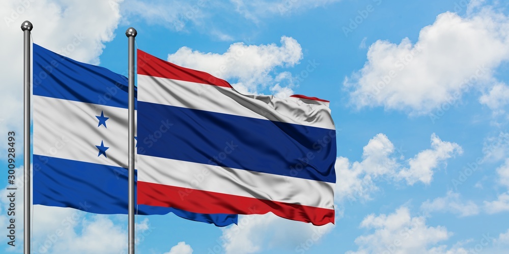 Honduras and Thailand flag waving in the wind against white cloudy blue sky together. Diplomacy concept, international relations.
