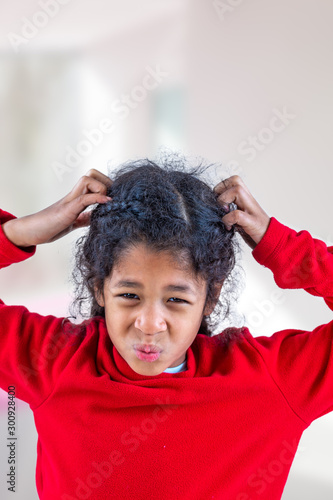 girl itchy his hair on isolated w indoors background, health care concept photo