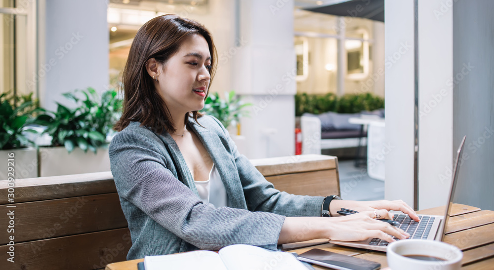 Confident freelancer sitting in cafe and typing Confident freelancer sitting in cafe and typing
