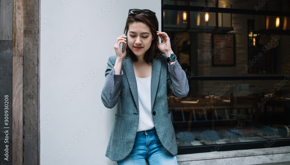 Charming Asian lady talking on phone