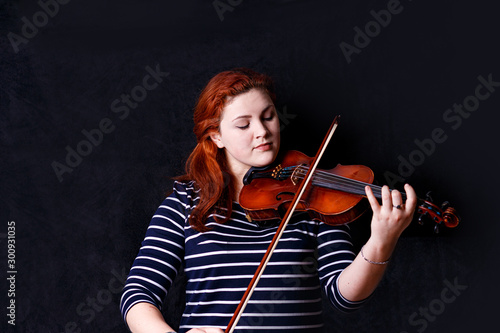 Red hair violin player young woman