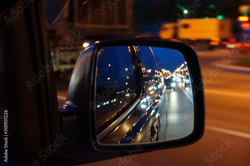 reflection in the side mirror of car traffic in the evening © Elena