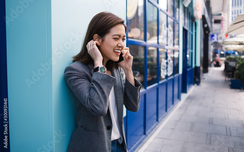 Contemporary young ethnic businesswoman talking on smartphone