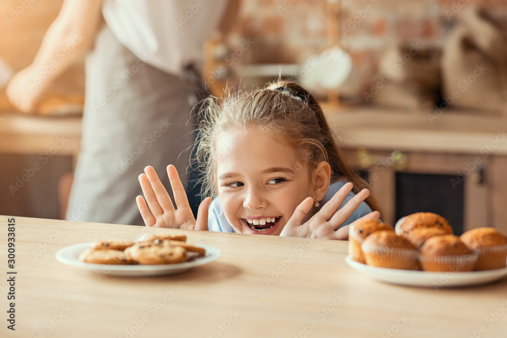 Emotional little girl looking with desire at sweets Emotional little girl looking with desire at sweets