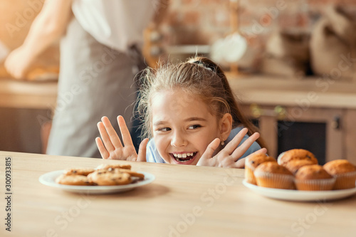 Emotional little girl looking with desire at sweets