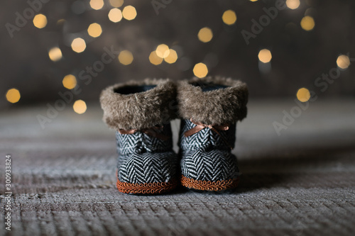 Holiday Christmas Baby Toy Small Boots on Wooden Table Background. Cozy Concept. photo