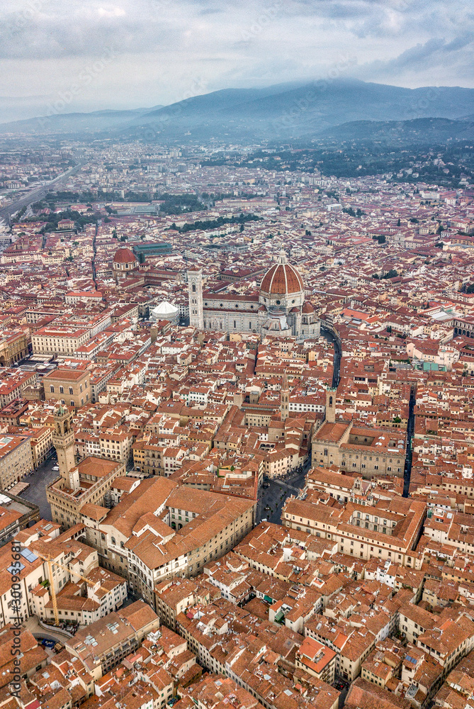 Aerial drone shot view of mountain square in Florence cityscape in the morning