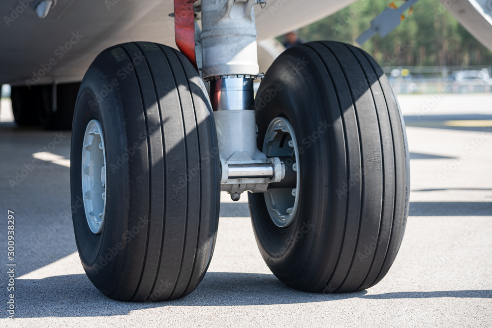 Detail shot with big airplane wheels and landing gear Detail shot with big airplane wheels and landing gear