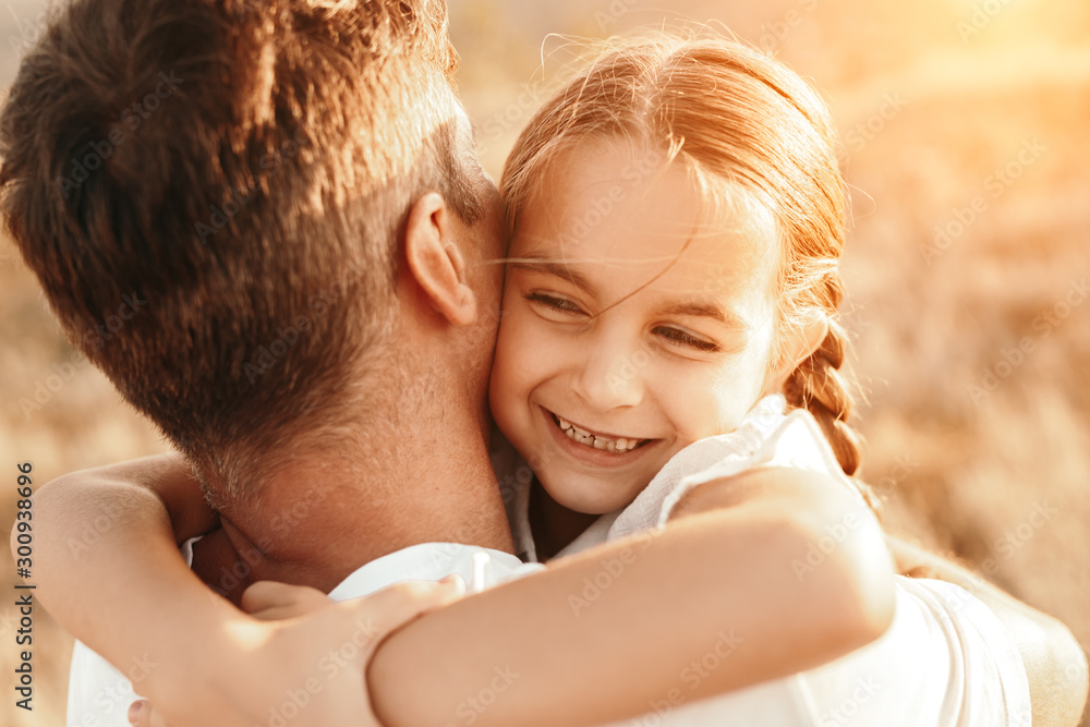 Happy daughter hugging father in nature Happy daughter hugging father in nature