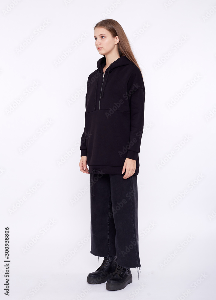 Young girl wearing blank and oversize black long hoody. White background Young girl wearing blank and oversize black long hoody. White background