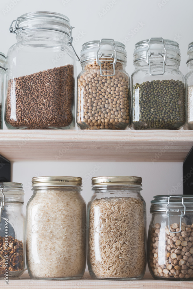 shelves with glass jars filled with groceries shelves with glass jars filled with groceries