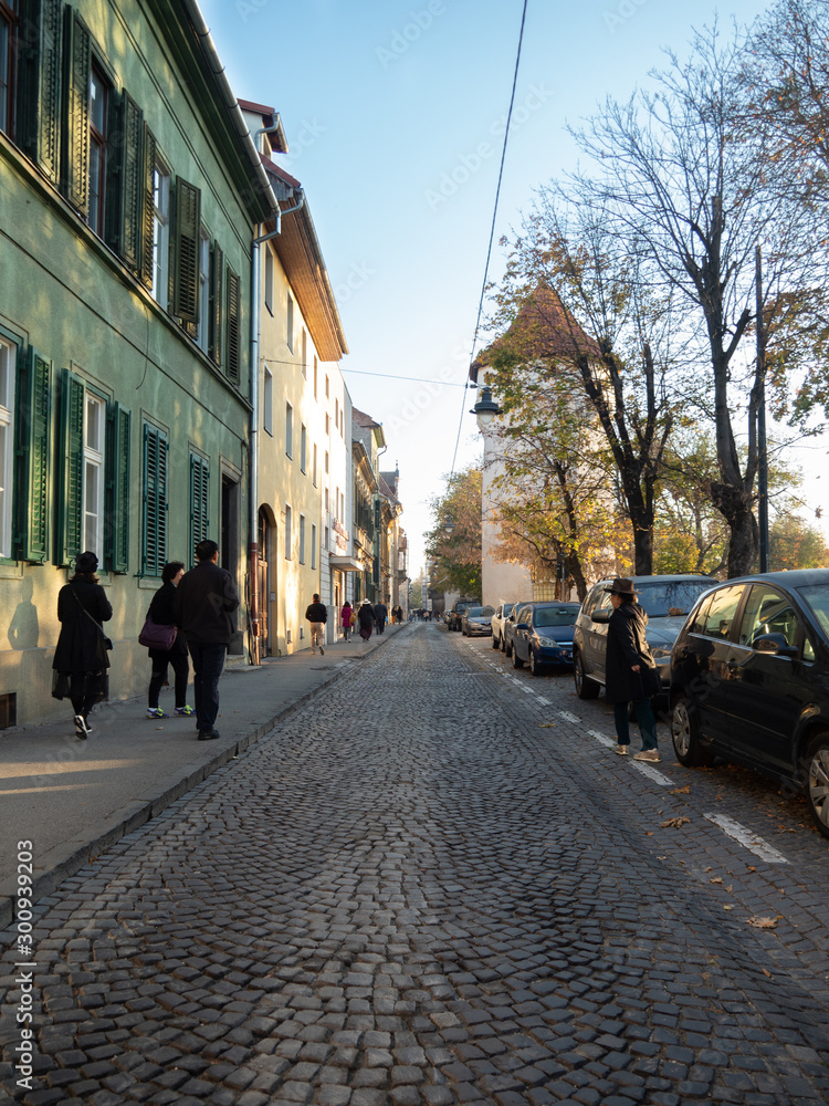 Tourists visiting well-preserved ancient town, Sibiu, in autumn.