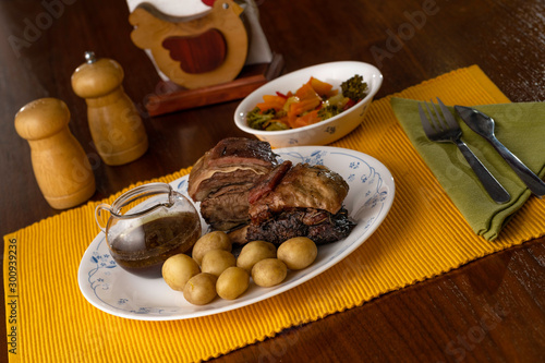 Short beef ribs, roasted with wine and rosemary, served with boiled potatoes and vegetables
