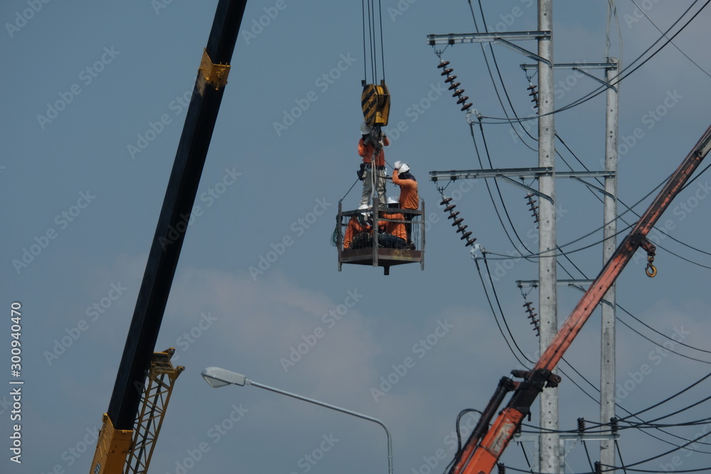 4 November 2019, Mae Sot, Thailand Electric officials are installing the high voltage electrical system. By using a crane And safety system 4 November 2019, Mae Sot, Thailand Electric officials are installing the high voltage electrical system. By using a crane And safety system
