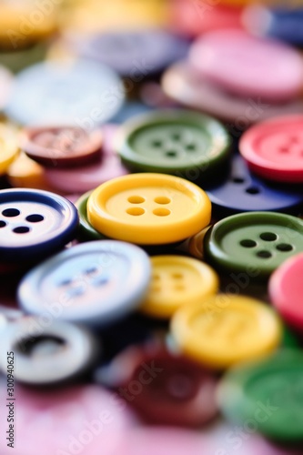 Large Group Of Colorful Plastic Sewing Buttons On Table