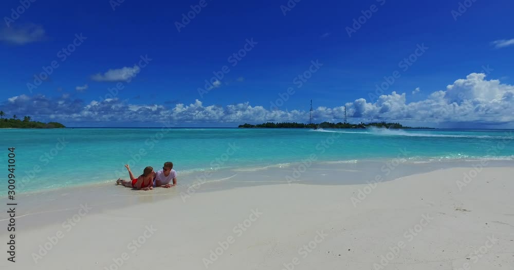 Couple in love talking about their relationship on a fabulous exotic background, jet ski on turquoise seawater Couple in love talking about their relationship on a fabulous exotic background, jet ski on turquoise seawater