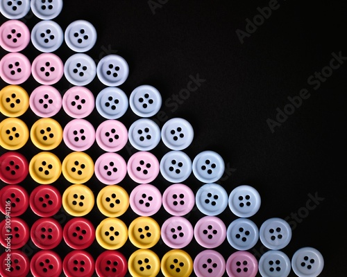 Large Group Of Colorful Plastic Sewing Buttons On Black Background