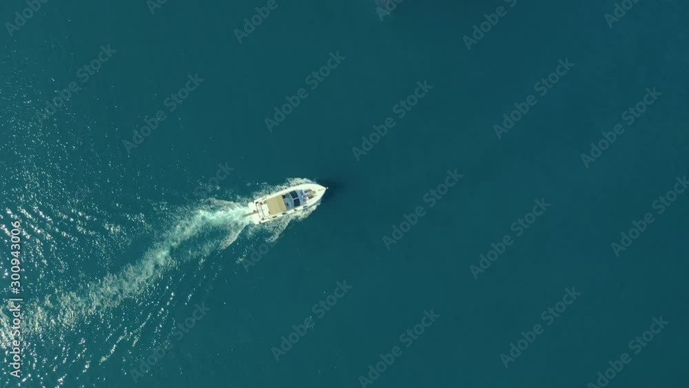 Medium sized Yacht roaring across The Mediterranean Sea - Top down aerial footage following the Yacht. Medium sized Yacht roaring across The Mediterranean Sea - Top down aerial footage following the Yacht.