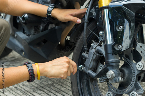 Mechanic fixing motocycle worn motorcycle drum breaks shoes. Professional training, repairing motorbike.