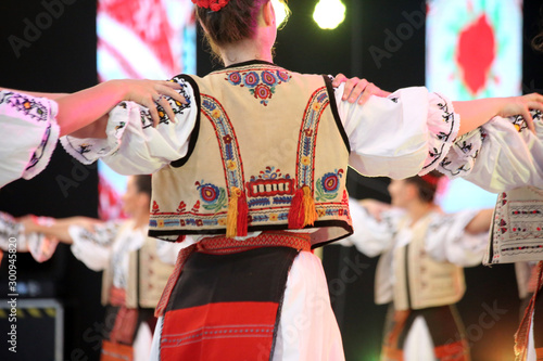 Papier peint Dancers hold hands in a traditional Romanian dance wearing traditional beautiful costumes