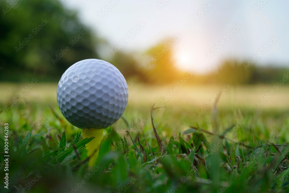 Golf ball on tee in beautiful golf course Golf ball on tee in beautiful golf course