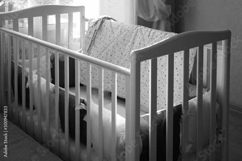 Baby bed crib with white and Burgundy color pillows with laces