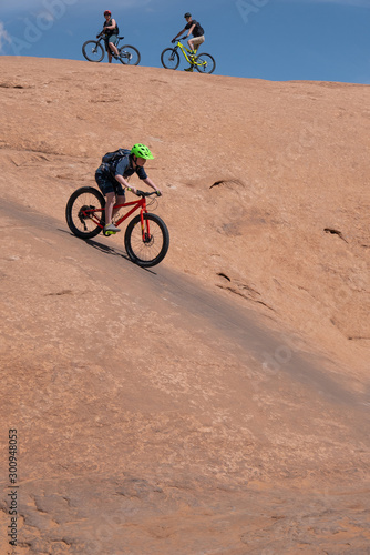 Obraz na płótnie Son, mother and grandfather riding mountain bikes of singletrack in Moab, Utah w salonie