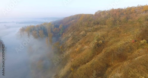 Aerial view of river under morning fog and golden hills, Ukraine photo