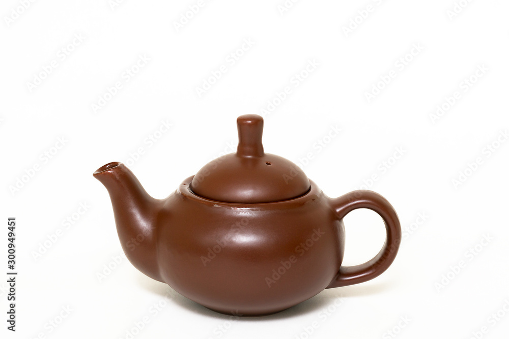 Clay utensils, a clay teapot on a white background. Close-up.
