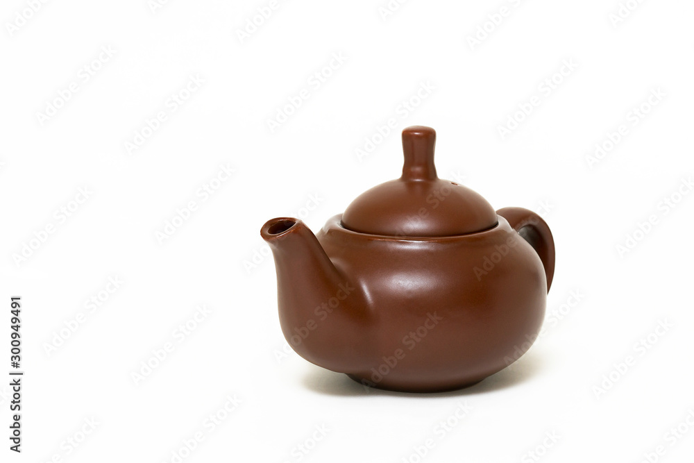 Clay utensils, a clay teapot on a white background. Close-up.