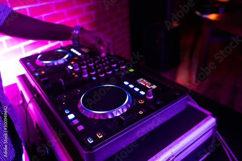DJ playing music.Midi controller turntable.New digital technology for mixing audio tracks.Sound mixer with turntables.Disc jockey mix music at party on summer festival