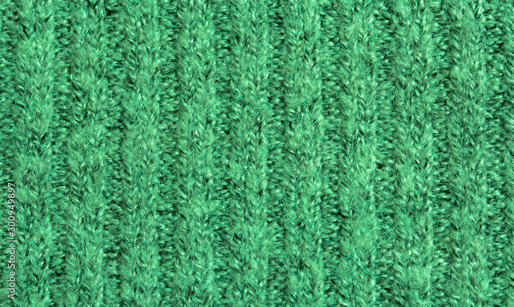 Background of green knitted fabric. Home made stitchwork. Background of green knitted fabric. Home made stitchwork.