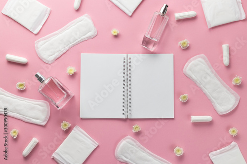 Tampons, feminine sanitary pads and empty paper on a pink background. Hygienic care on critical days. menstrual cycle. Caring for women's health. Monthly protection. Flat lay, top view, copy space.