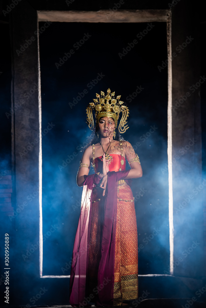 Fototapeta premium Portrait of asian woman wear ancient thai dress style and makeup ghost face at the old castles at night scene,Thailand people