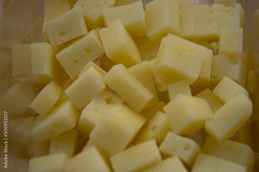 Manchego cheese cut into square pieces for foreground tasting Manchego cheese cut into square pieces for foreground tasting