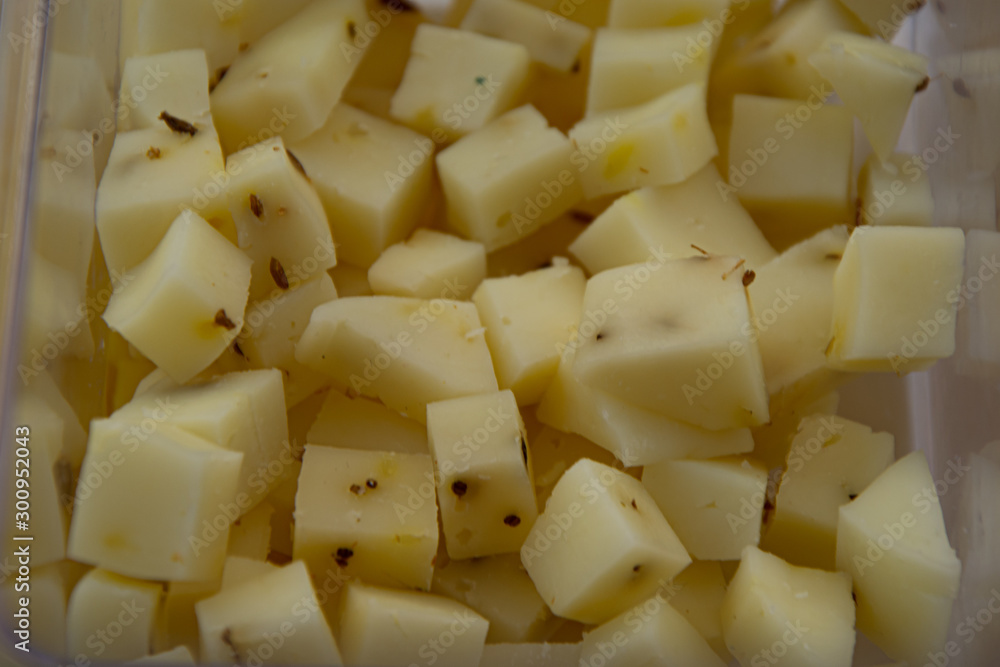 Manchego cheese cut into square pieces for foreground tasting Manchego cheese cut into square pieces for foreground tasting