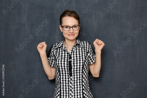 Portrait of happy young woman celebrating her achievements