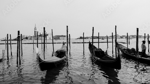 Black and white photo of gondola and gondolier taken in the beautiful city of Venice, Italy