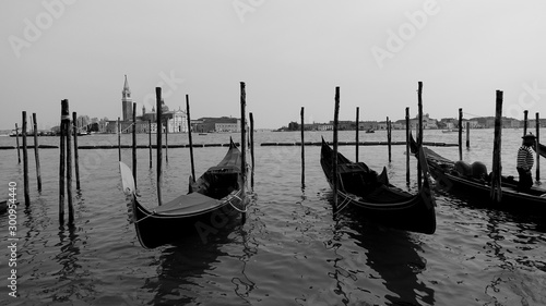 Black and white photo of gondola and gondolier taken in the beautiful city of Venice, Italy