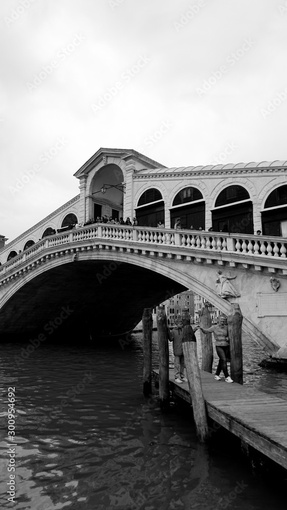 Black and white photo of Rialto Bridge taken in the beautiful city of Venice, Italy